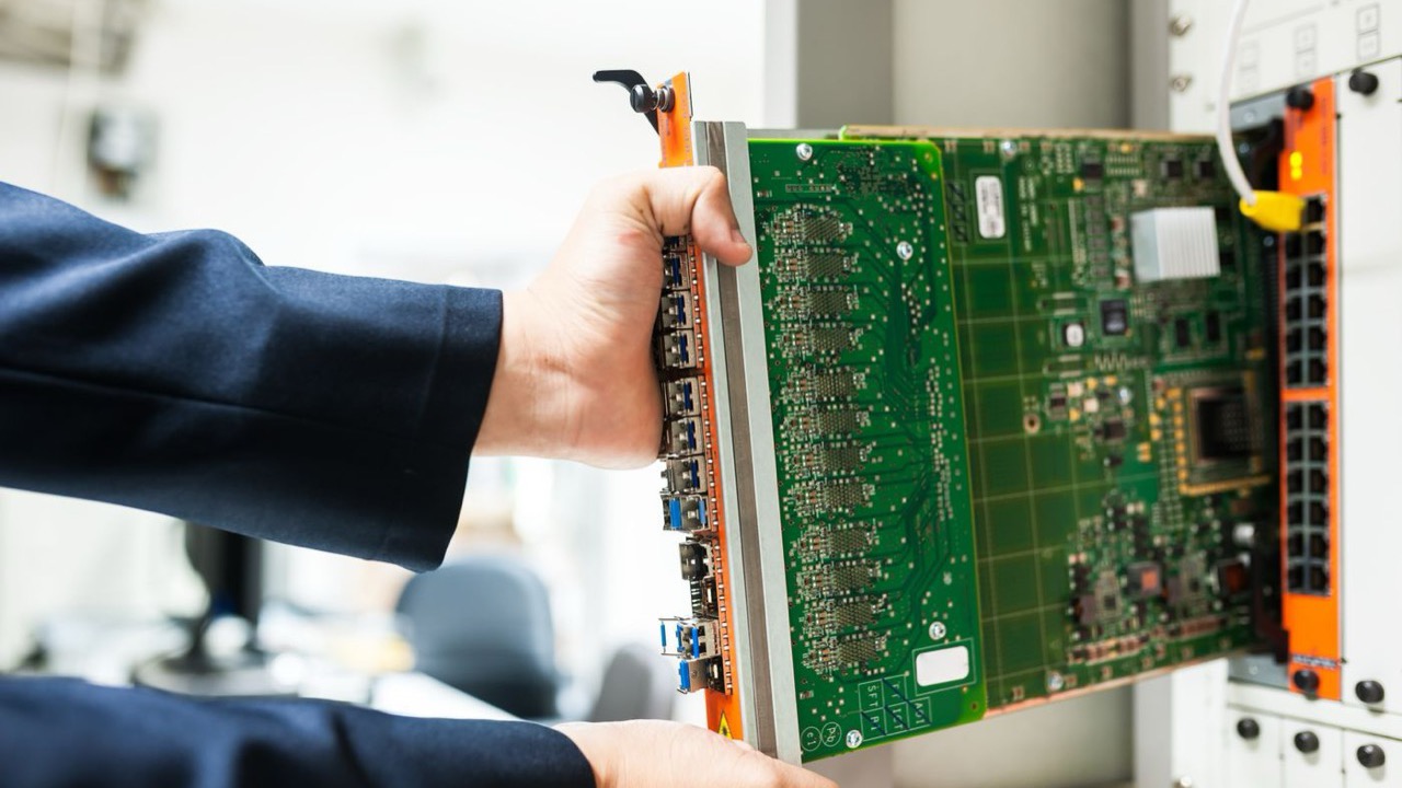 Technician installing a hardware module into a server rack
